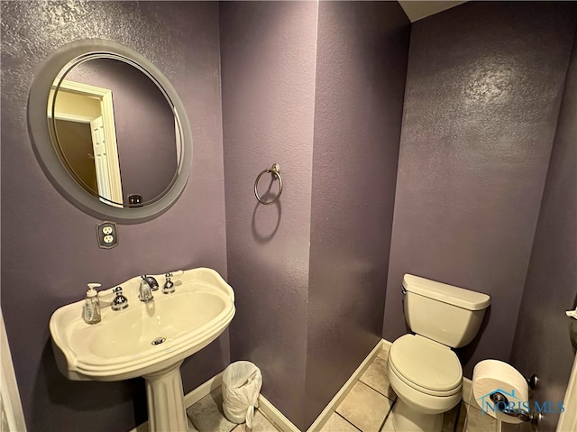 bathroom featuring sink, tile patterned flooring, and toilet