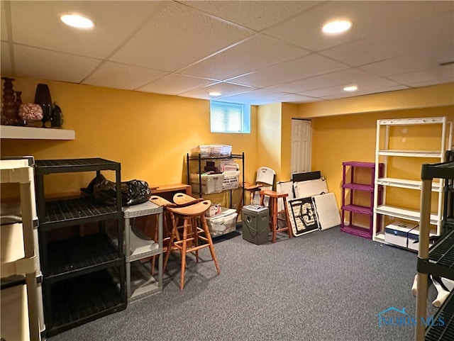 interior space featuring carpet and a drop ceiling