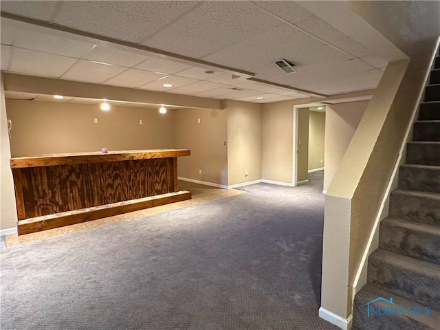 basement with carpet flooring and a drop ceiling