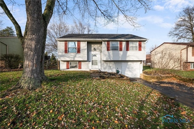 split foyer home with a front lawn and a garage