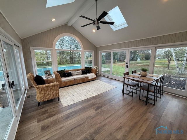 sunroom / solarium featuring ceiling fan and lofted ceiling with skylight