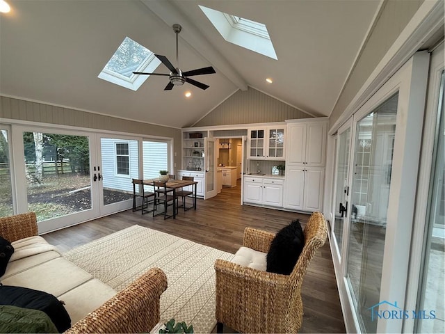 living room featuring lofted ceiling with beams, ceiling fan, and dark hardwood / wood-style floors