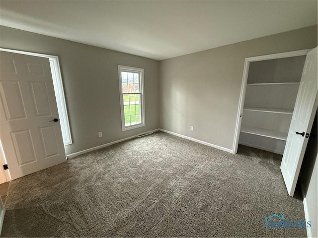 unfurnished bedroom featuring dark colored carpet