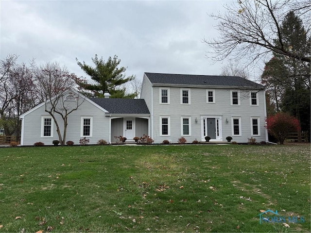 colonial-style house with a front lawn