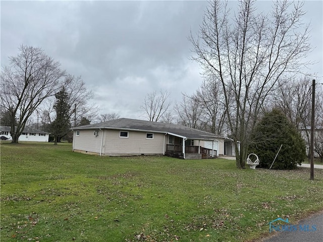 view of front of home with a front lawn and a garage