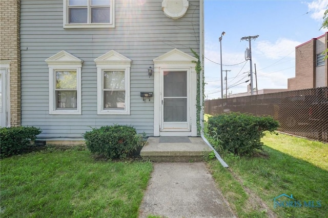 doorway to property featuring a yard