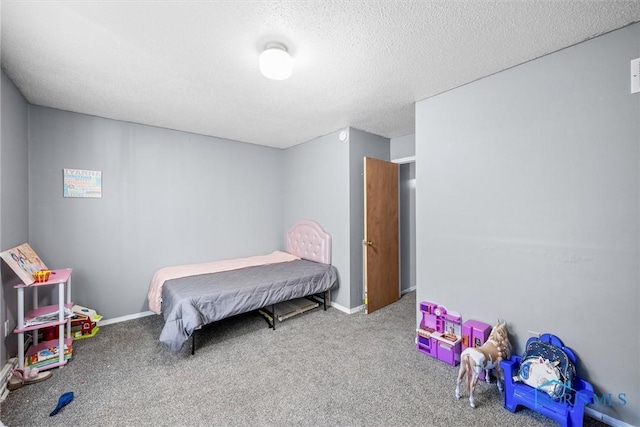 carpeted bedroom featuring a textured ceiling