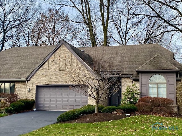 view of front facade with a garage and a front lawn