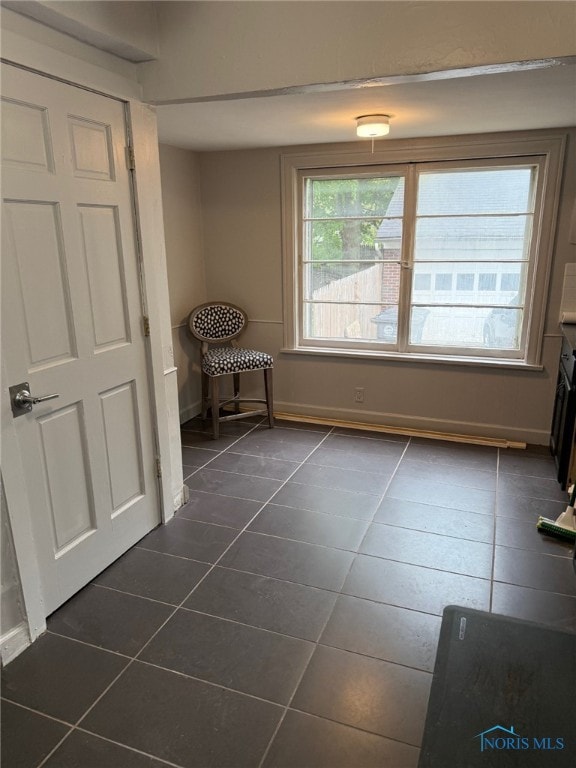 4127 Burnham Ave, Toledo, OH 43612 - unfurnished dining area with dark tile patterned floors and baseboards