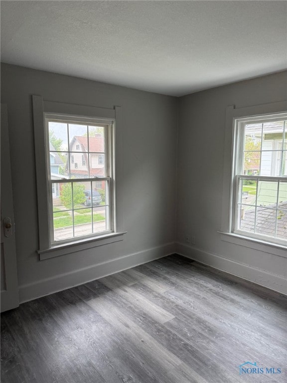 4127 Burnham Ave, Toledo, OH 43612 - spare room featuring dark wood-style floors and baseboards