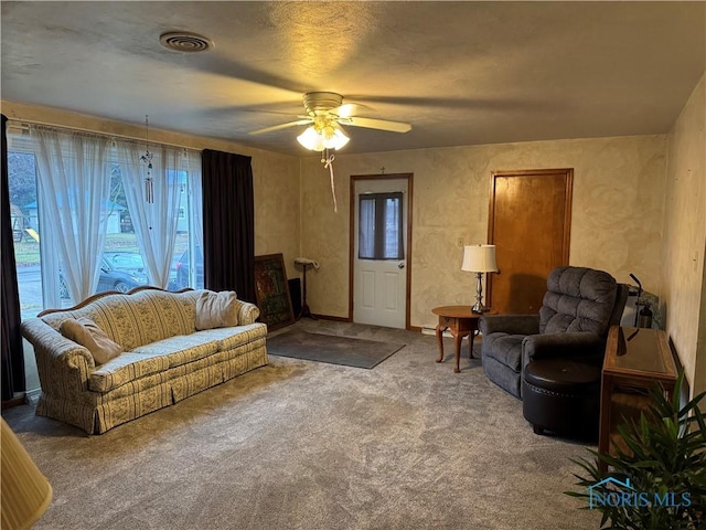 carpeted living room with ceiling fan