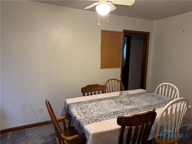 carpeted dining area featuring ceiling fan