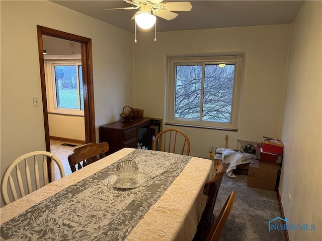 dining area with ceiling fan and carpet floors