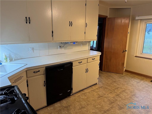 kitchen featuring black appliances, white cabinets, and sink