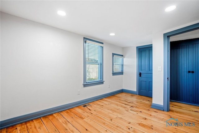 unfurnished bedroom with hardwood / wood-style flooring