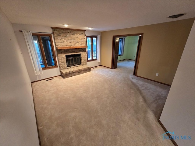 unfurnished living room featuring a fireplace and light carpet