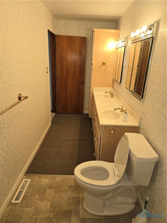 bathroom with vanity and toilet