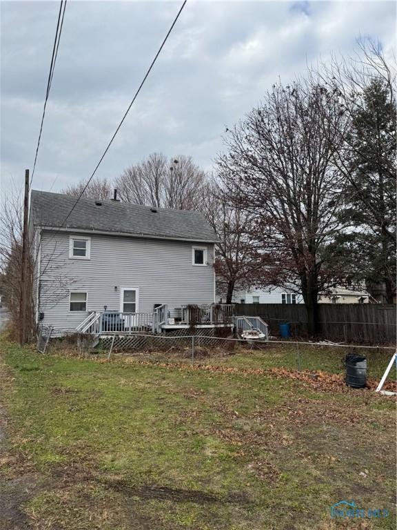 rear view of house with a wooden deck