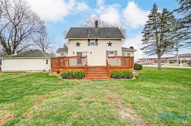 rear view of house featuring a lawn and a deck