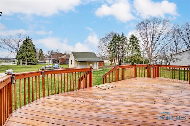 deck featuring an outdoor structure and a lawn