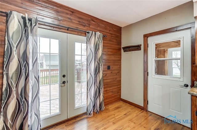 entryway featuring light hardwood / wood-style floors, a wealth of natural light, and french doors