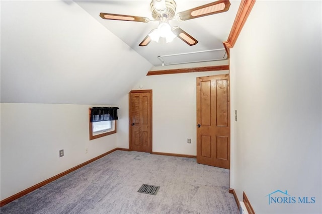 additional living space featuring ceiling fan, lofted ceiling, and light carpet