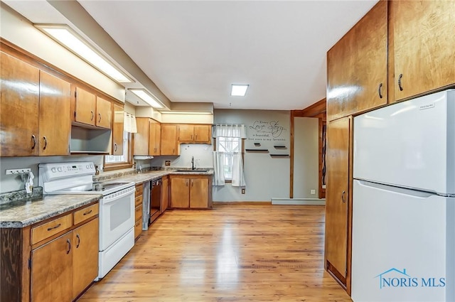 kitchen with light wood-type flooring, white appliances, baseboard heating, and sink