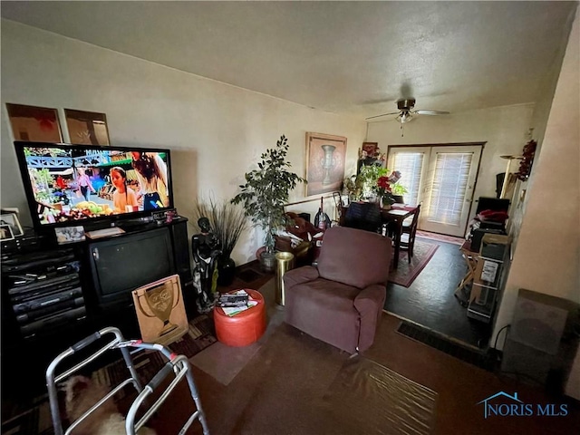 living room with ceiling fan and dark carpet