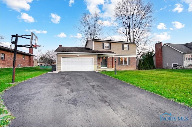 view of property with a garage and a front yard