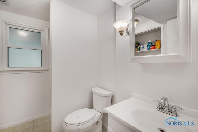 bathroom featuring tile patterned floors, vanity, and toilet