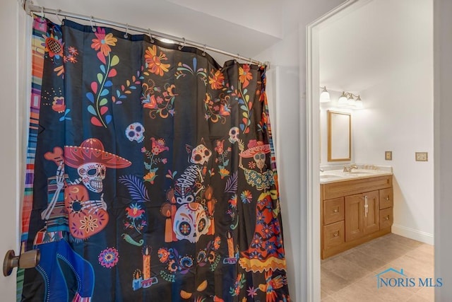 bathroom with a shower with curtain, vanity, and tile patterned floors