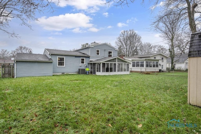 rear view of house featuring a yard, cooling unit, and a sunroom