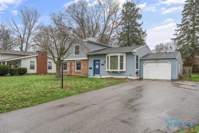 tri-level home featuring a garage and a front yard