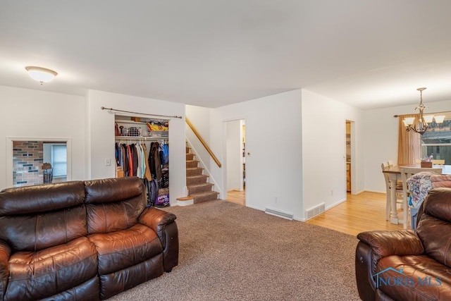 living room with light hardwood / wood-style flooring and a notable chandelier