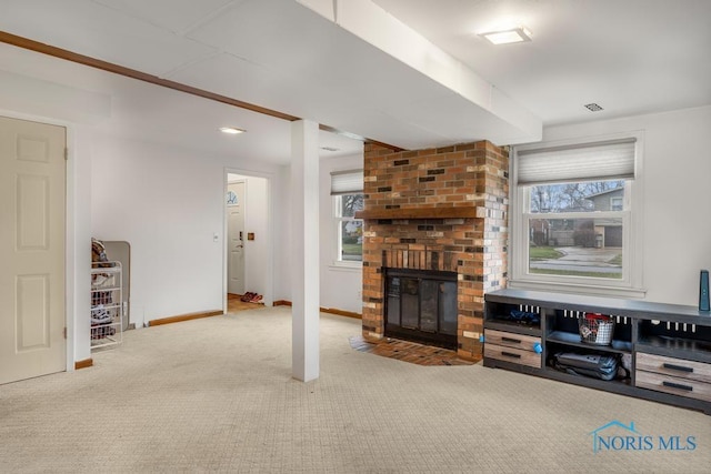 living room featuring carpet flooring and a fireplace