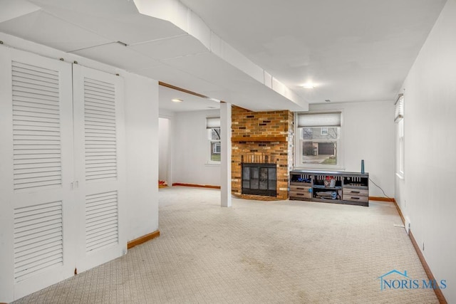 living room with a fireplace and carpet floors