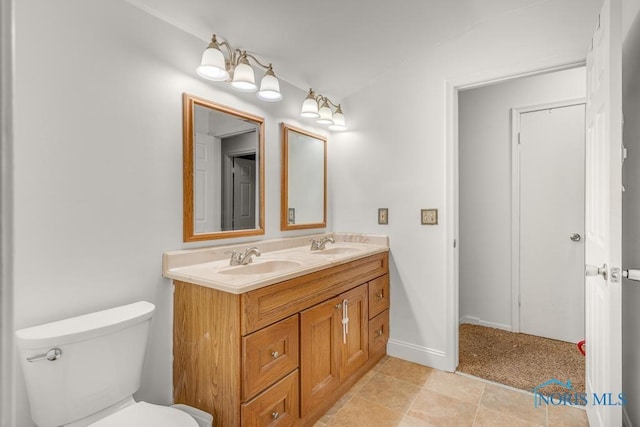 bathroom featuring tile patterned floors, vanity, and toilet