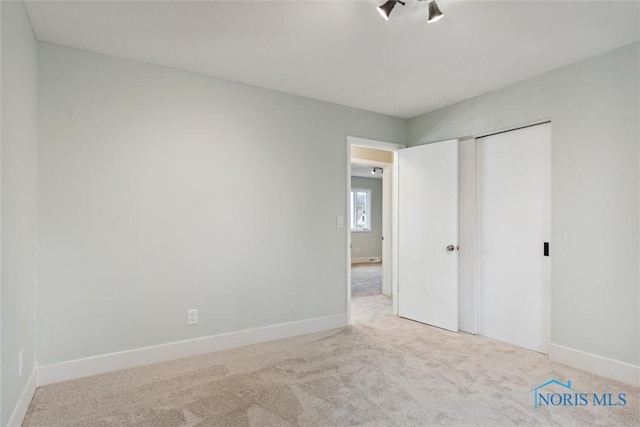 unfurnished bedroom with carpet flooring and a closet