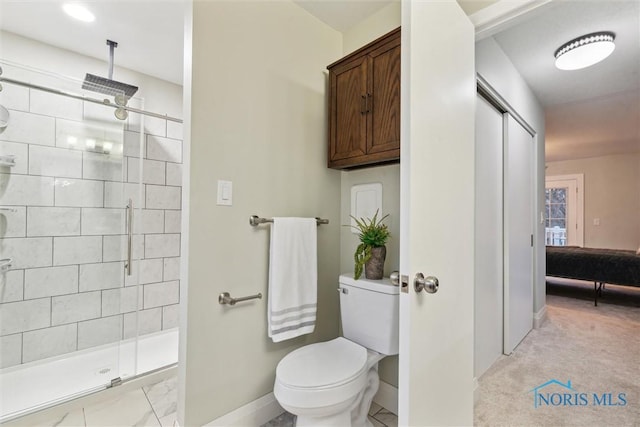 bathroom with an enclosed shower and toilet