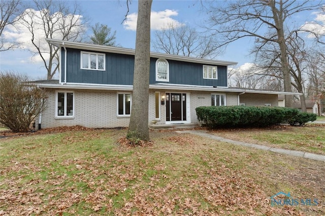 rear view of property with a lawn