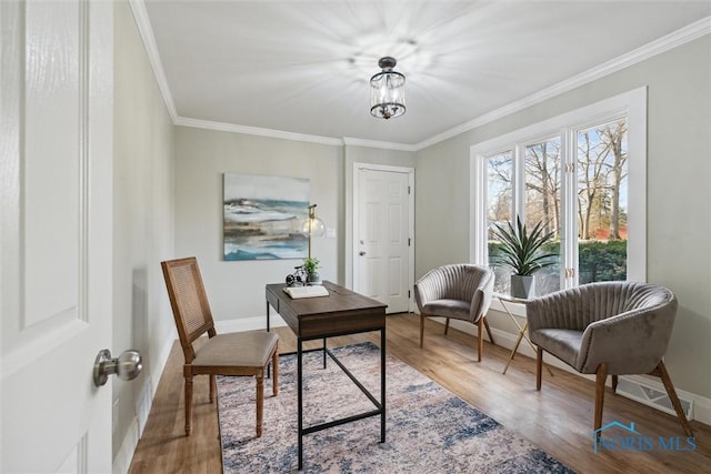 office with wood-type flooring, ornamental molding, and a notable chandelier