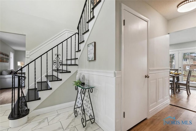 staircase featuring french doors and hardwood / wood-style flooring