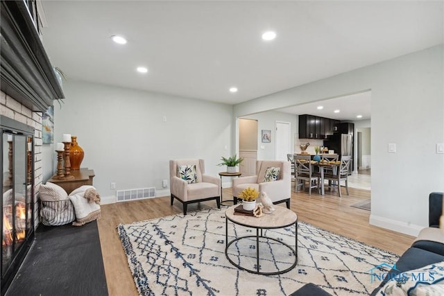 living room featuring a fireplace and light hardwood / wood-style floors