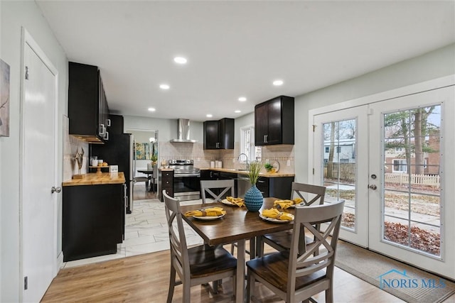 dining room featuring french doors, light hardwood / wood-style floors, and sink