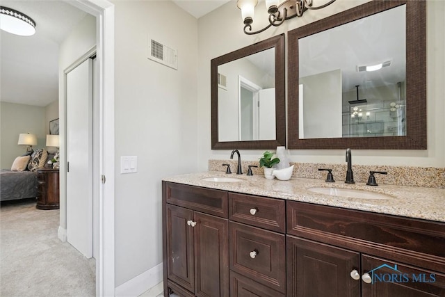 bathroom with a shower with door and vanity