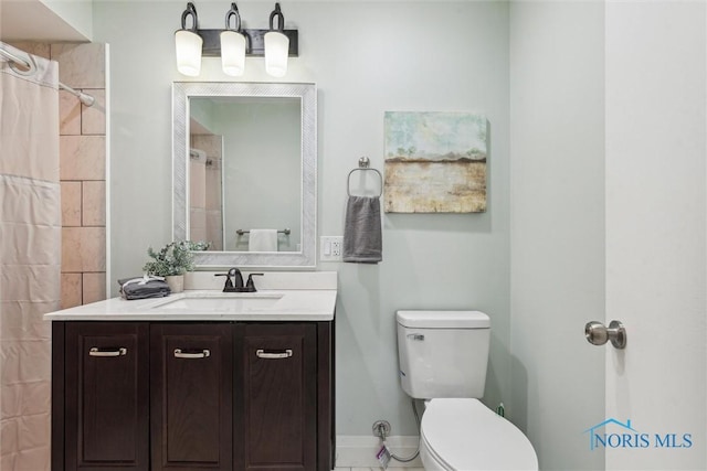 bathroom with vanity, toilet, and walk in shower