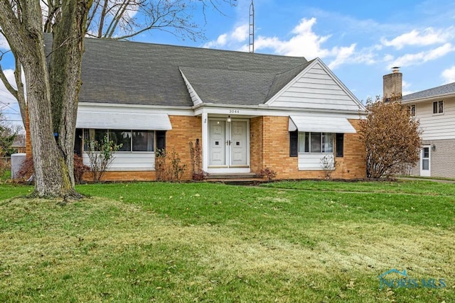 ranch-style home with a front lawn