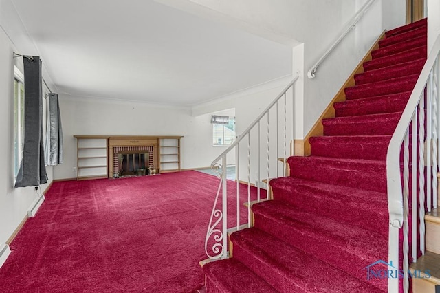 stairway featuring carpet flooring and a fireplace