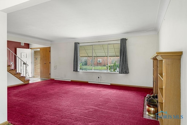 carpeted spare room with crown molding and a baseboard radiator