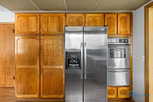 kitchen featuring light wood-type flooring and appliances with stainless steel finishes